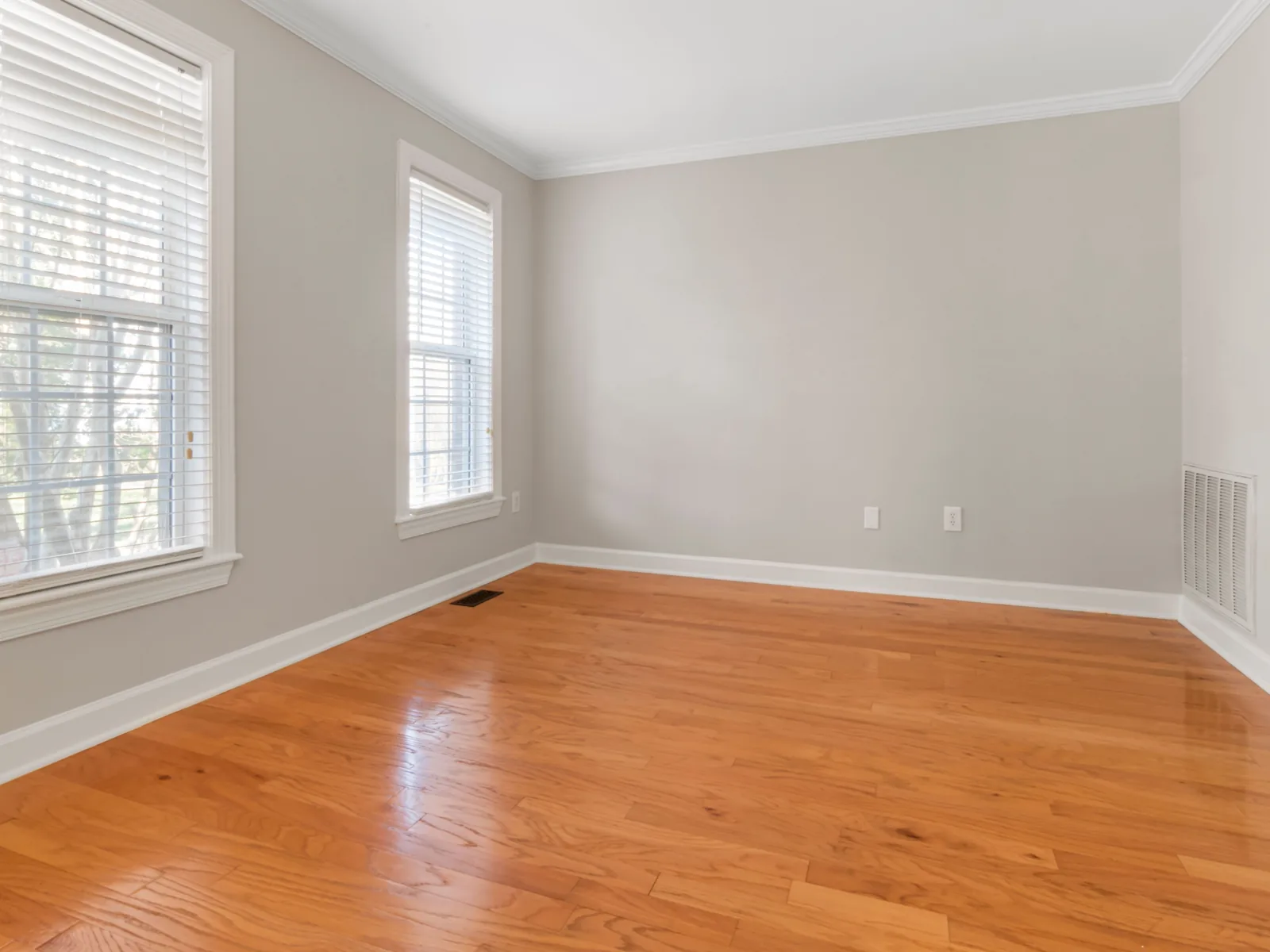 Bright room with new oak flooring installed wall to wall