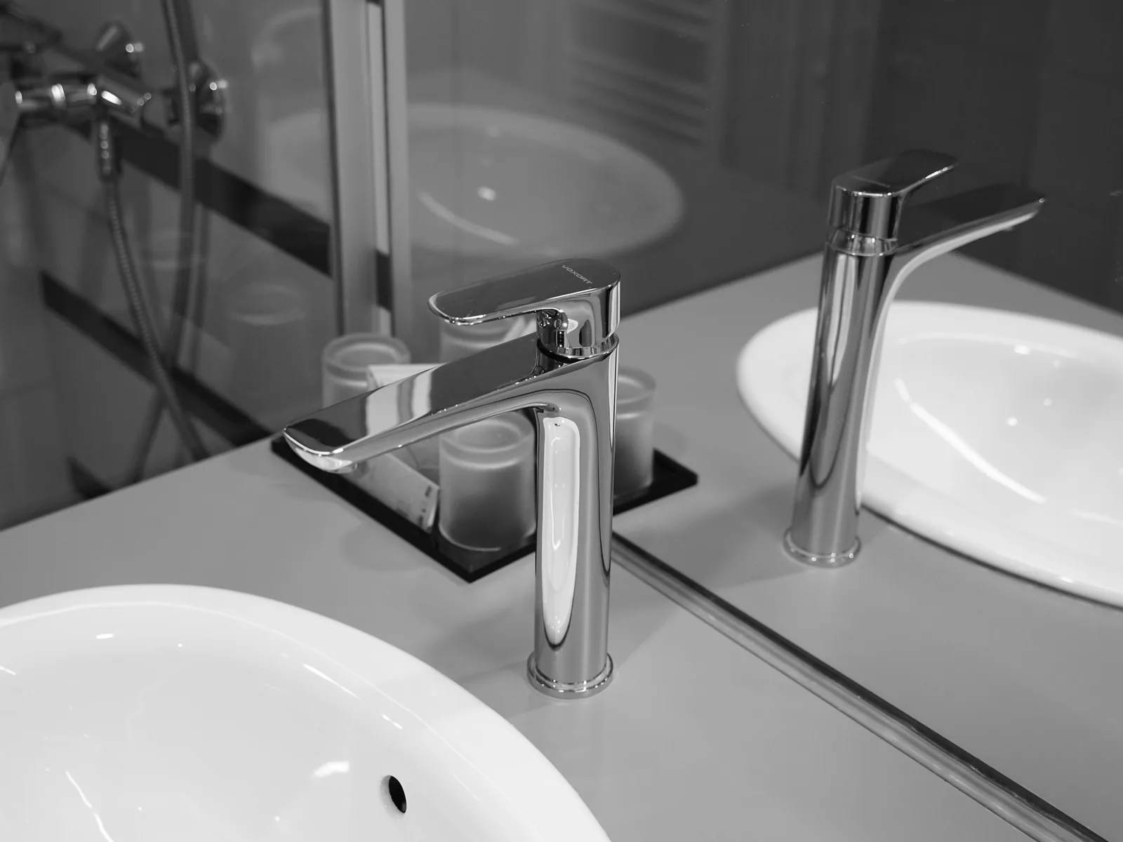 Modern chrome faucet installed on a white bathroom sink